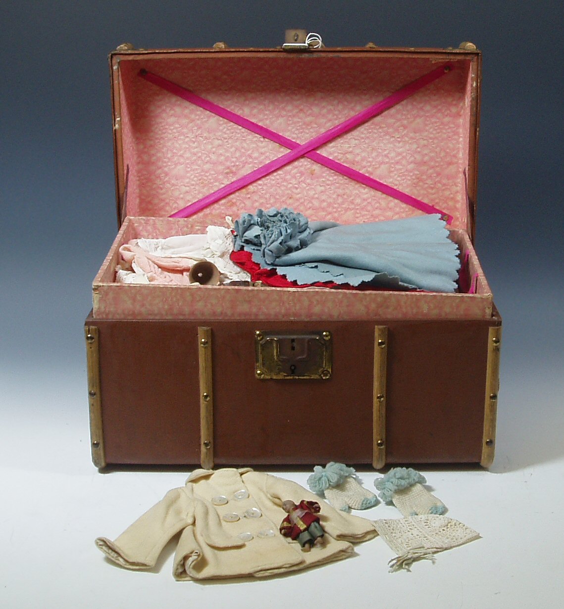 A collection of late 19th century/early 20th century dolls costume,