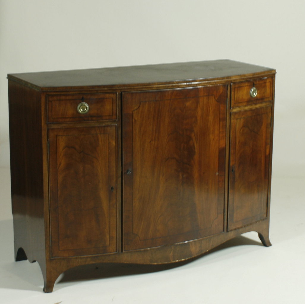An Edwardian bow fronted feathered mahogany cabinet by Royal appointment Maple & Co.