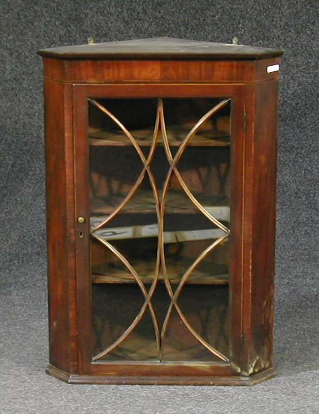 A George III mahogany hanging corner cabinet,