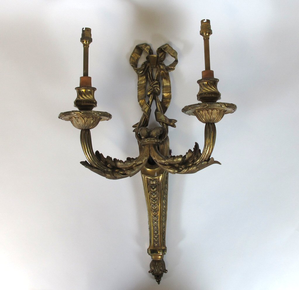 A pair of late 19th century French Empire style gilt metal wall sconces