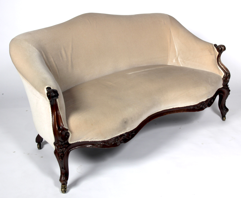 A Victorian carved mahogany framed settee