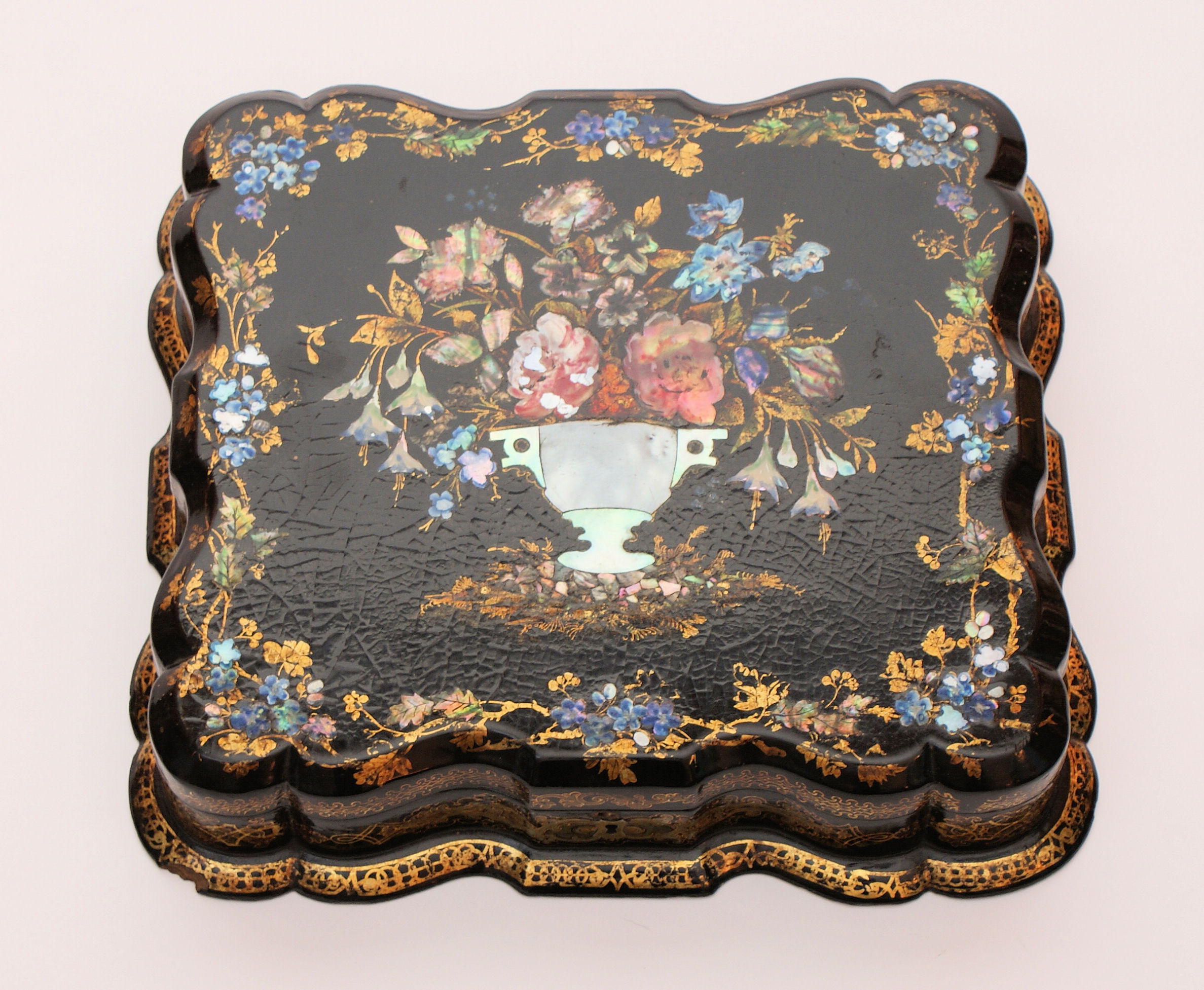 A Victorian papier mache painted gilt and mother-of-pearl inlaid box and cover