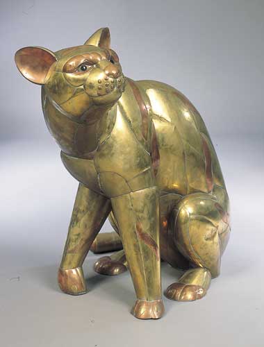 A brass and copper figure of a seated cat