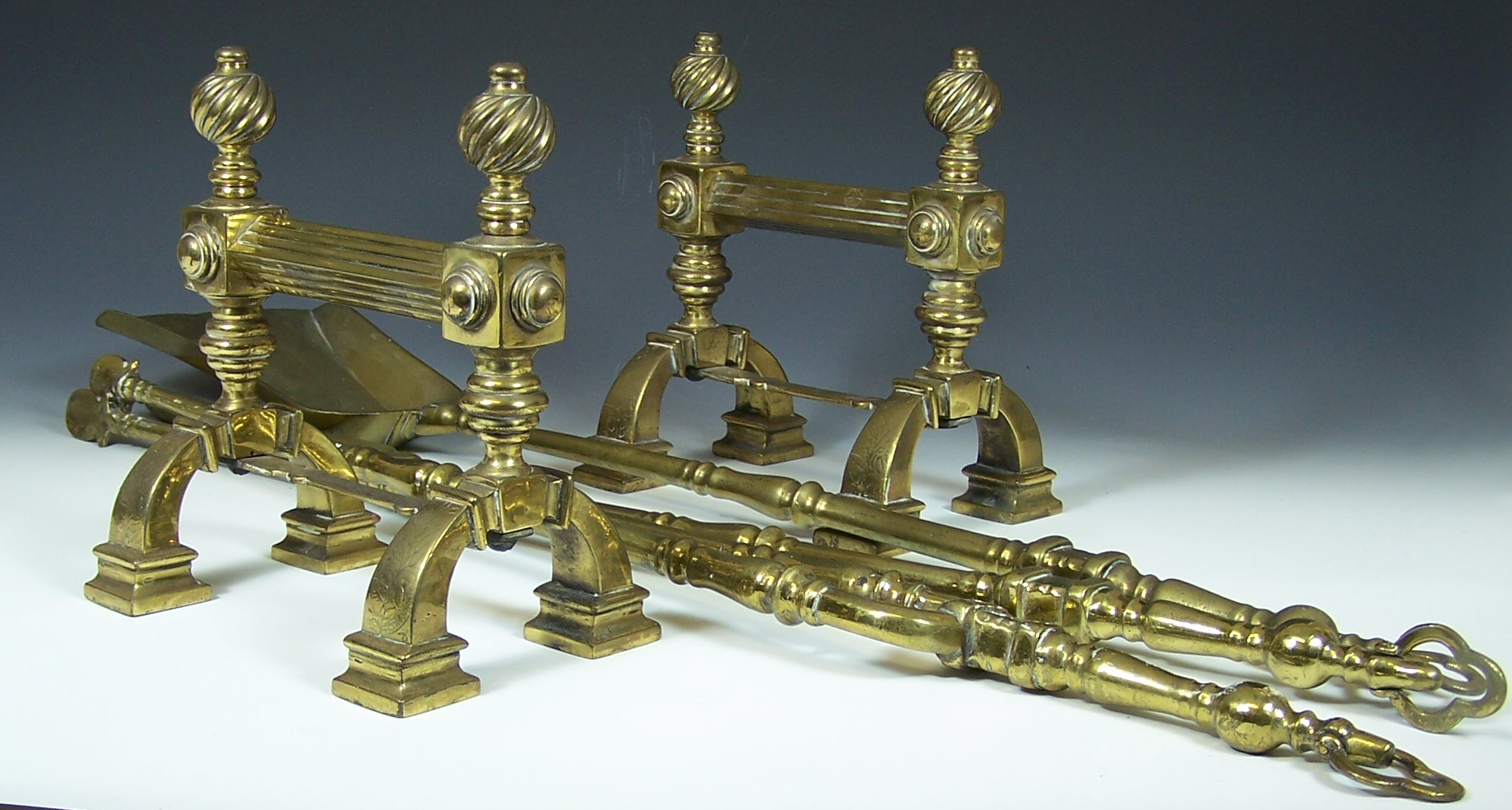 A set of three brass fire irons,