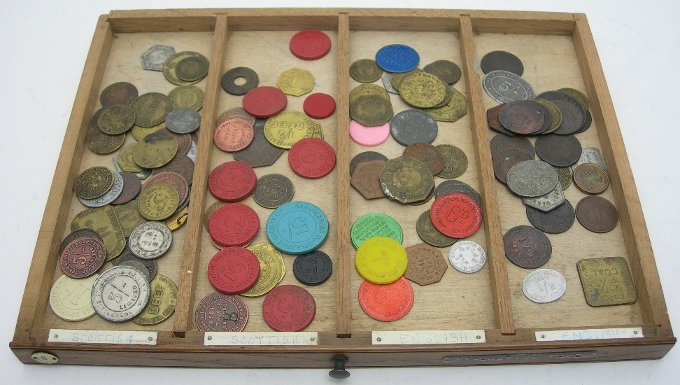 A COIN COLLECTION IN AN OAK COLLECTORS CABINET FITTED WITH TWENTY DRAWERS AND CONTAINING
