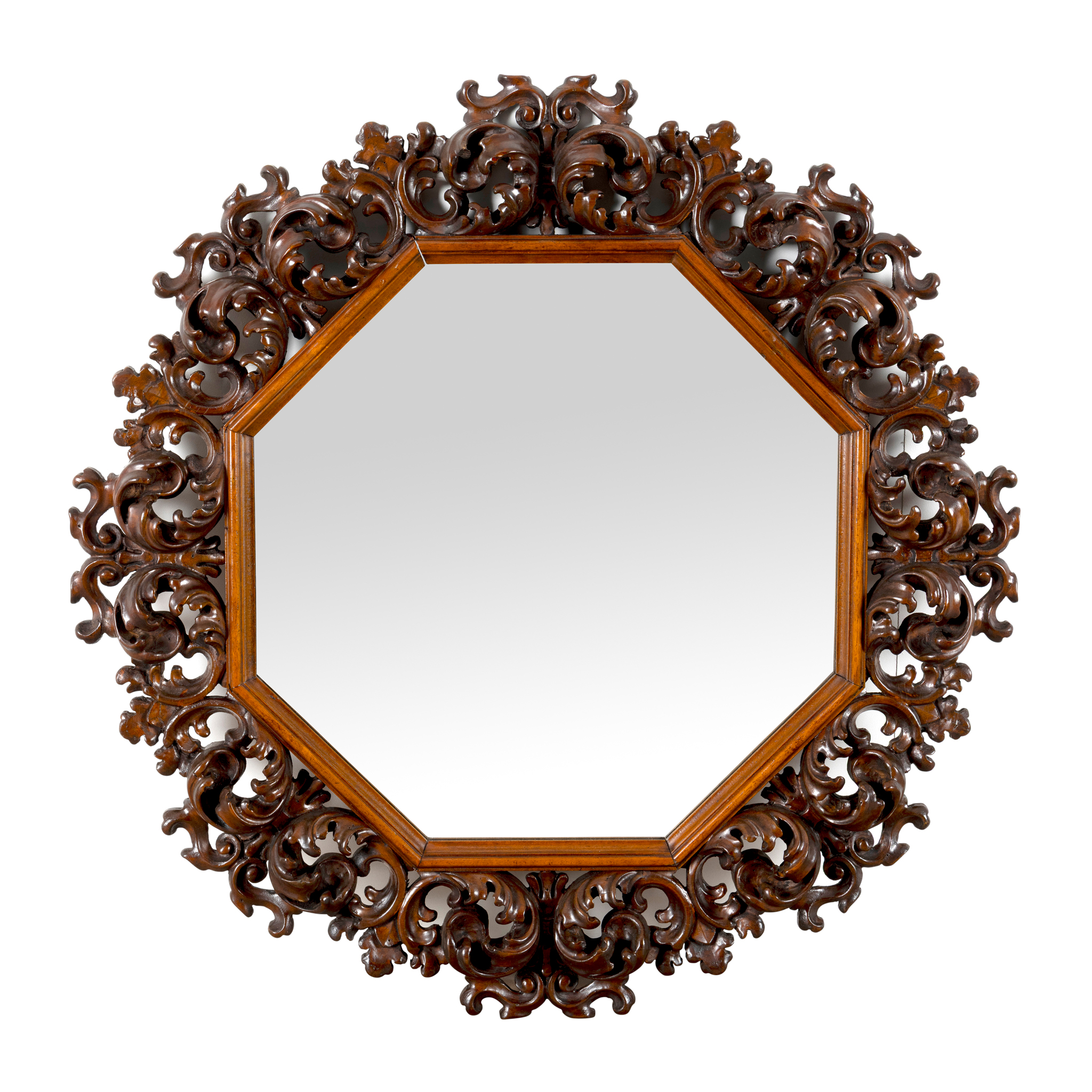 A CARVED WALNUT OCTAGONAL WALL MIRROR