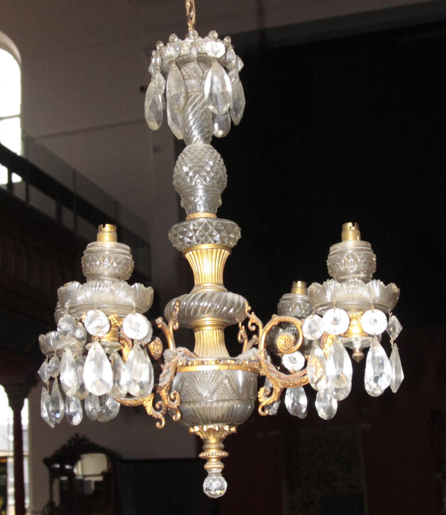 A gilt metal and cut glass four branch chandelier