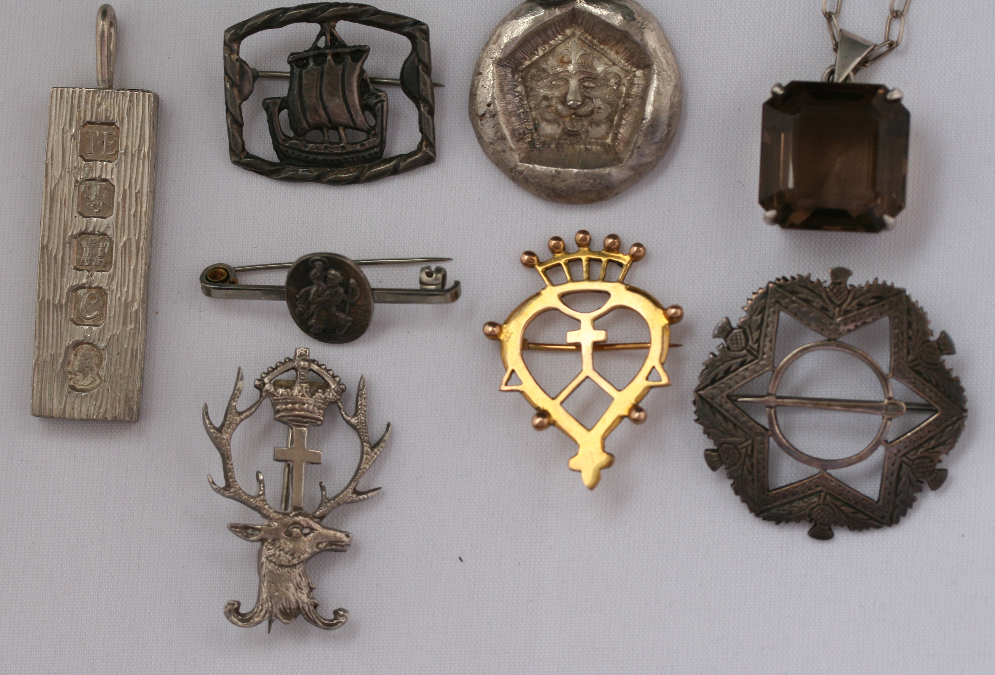 A collection of Scottish and other silver brooches to include;