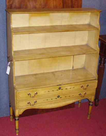 A pair of Regency style painted open low bookcases