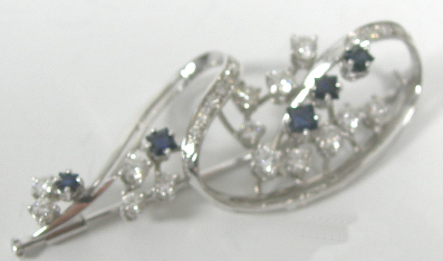 A sapphire and diamond set brooch,