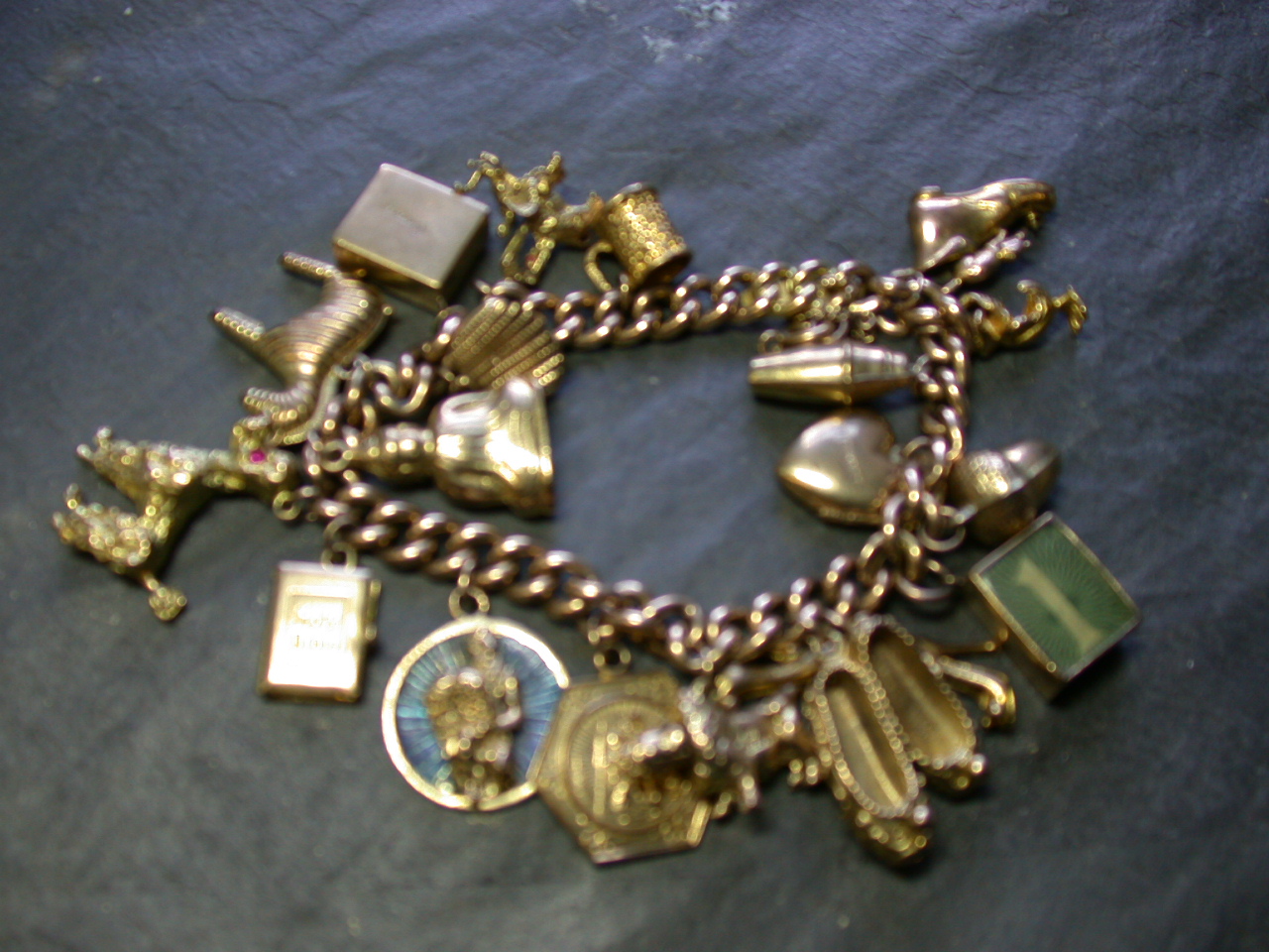 A 15ct gold curb link charm bracelet,