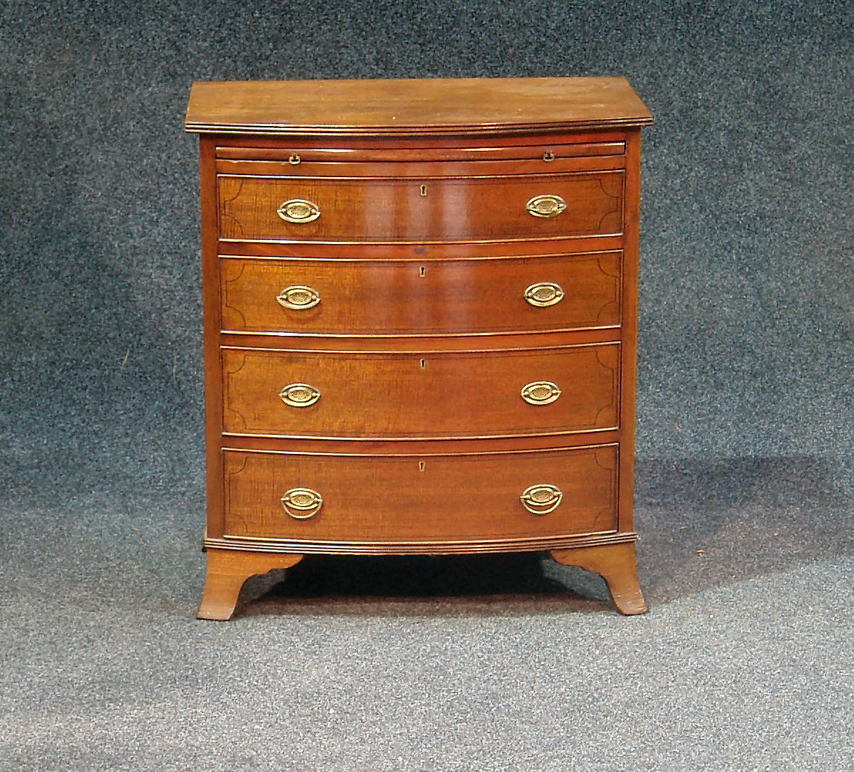 A fiddle back mahogany bachelor's chest,