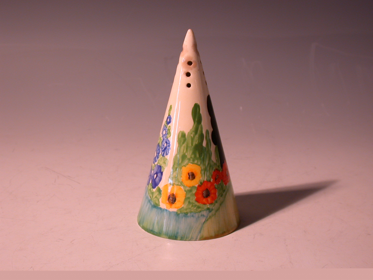 A Clarice Cliff conical sugar sifter