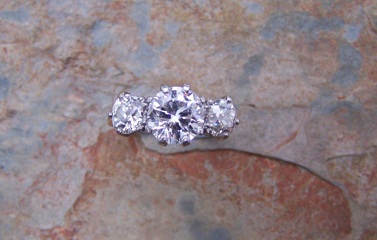 An 18ct gold and platinum mounted three-stone diamond ring,