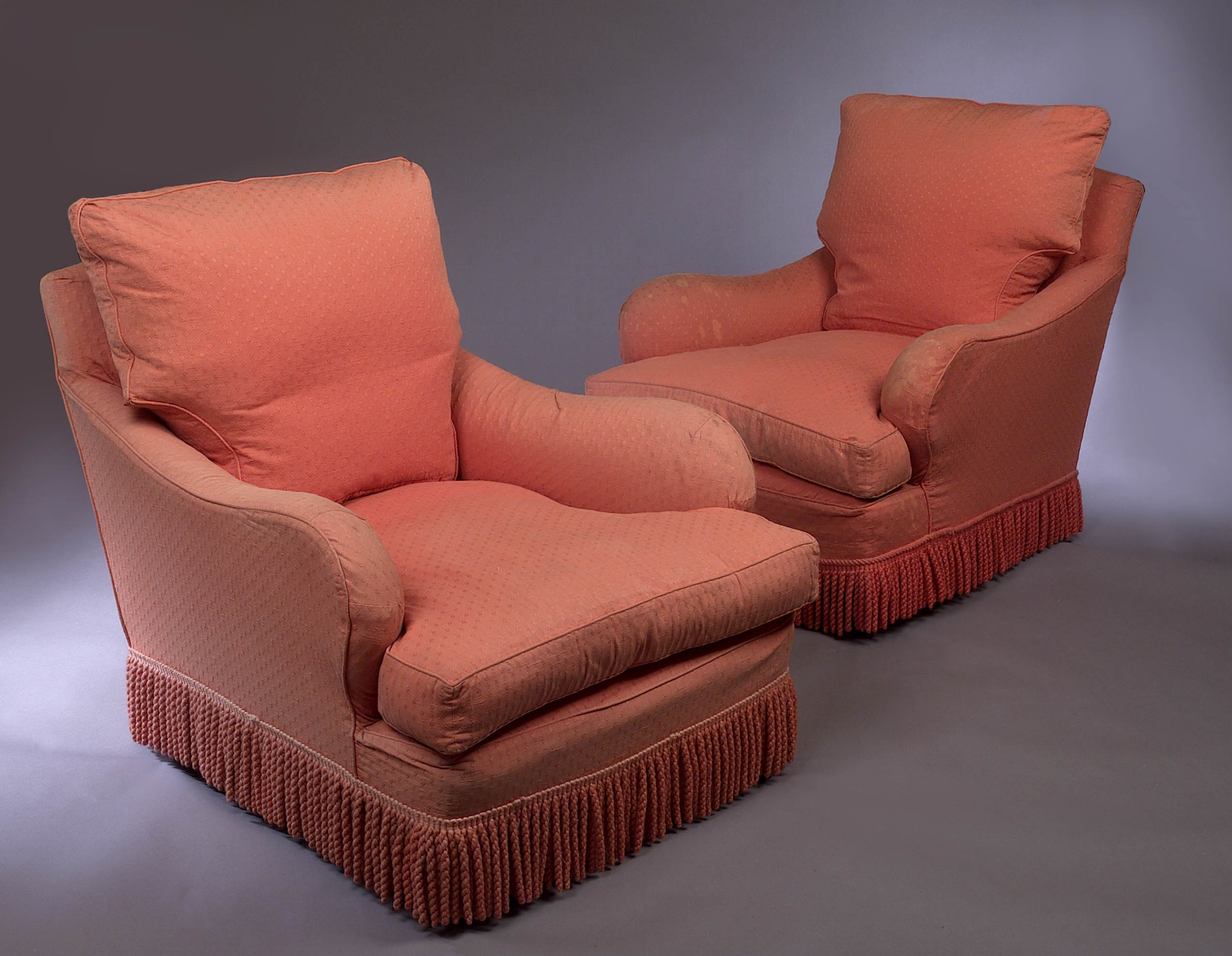 A pair of easy armchairs