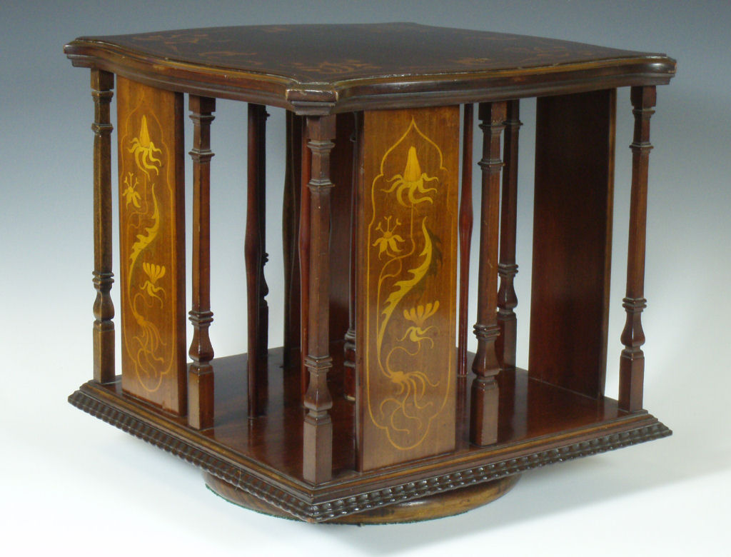An Art Nouveau mahogany revolving bookcase In the manner of Shapland & Petter of Barnstaple