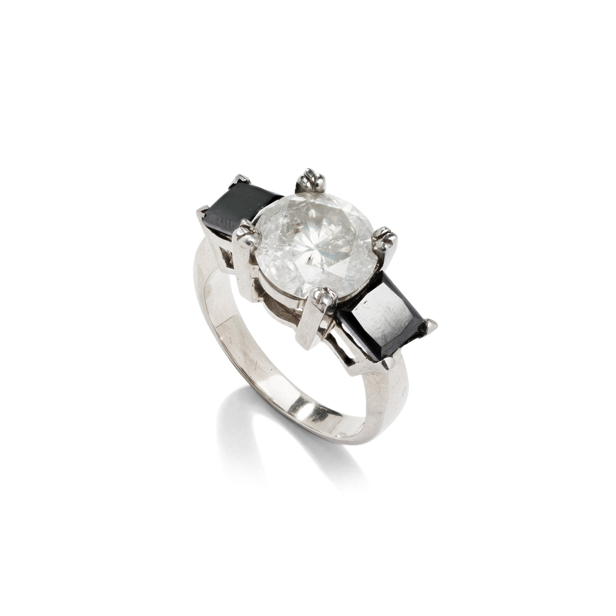A black and colourless diamond three-stone ring