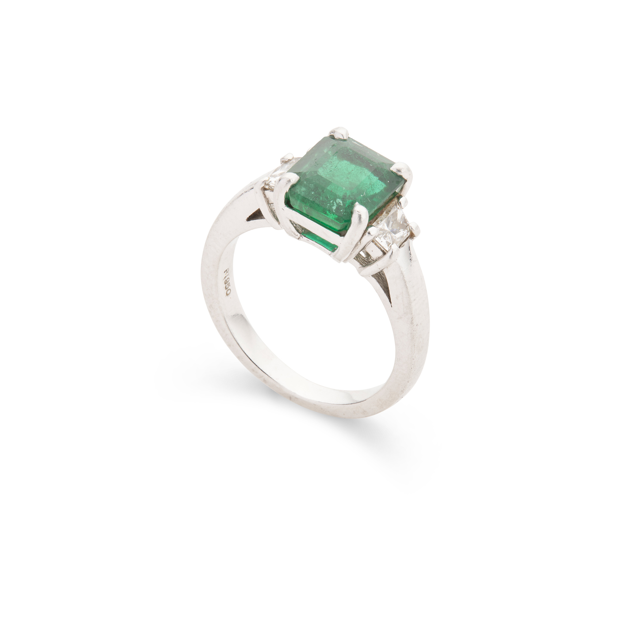 An emerald and diamond three-stone ring