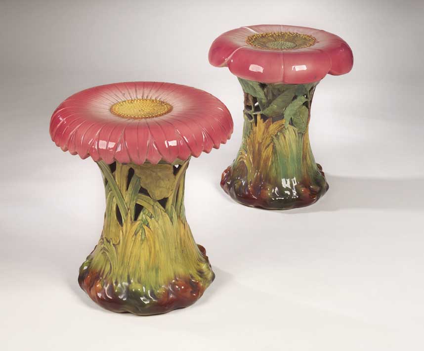 A near pair of Delphin Massier faience garden seats,