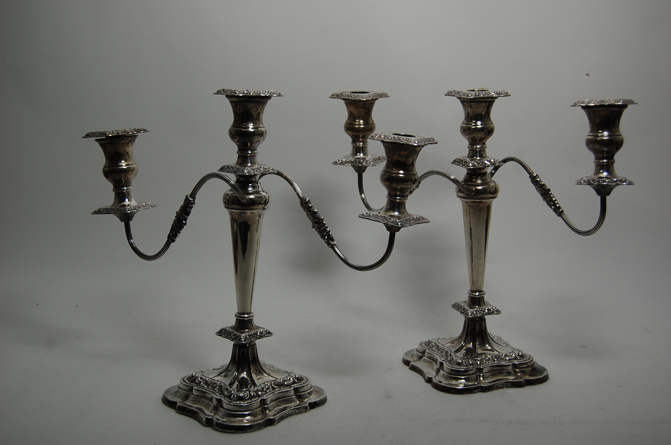 A pair of Regency style silver table candelabra