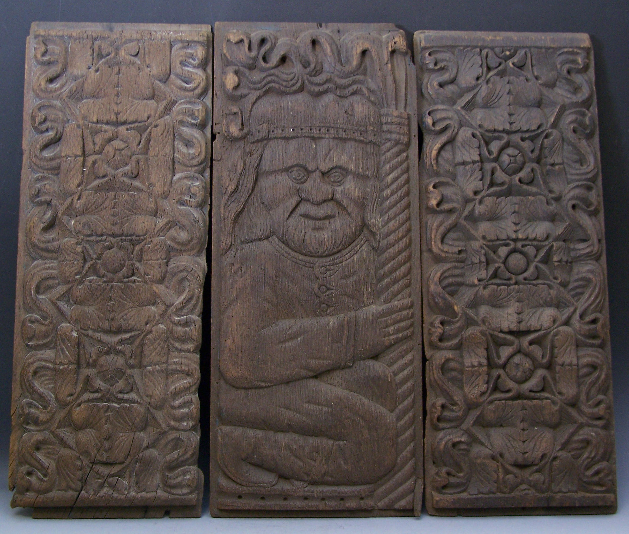 Three carved oak panels,