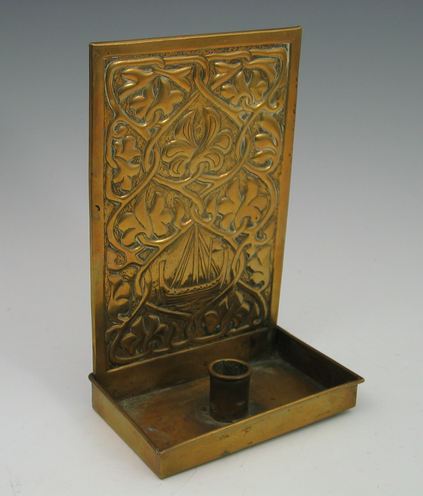 An Alexander Ritchie brass candle sconce,