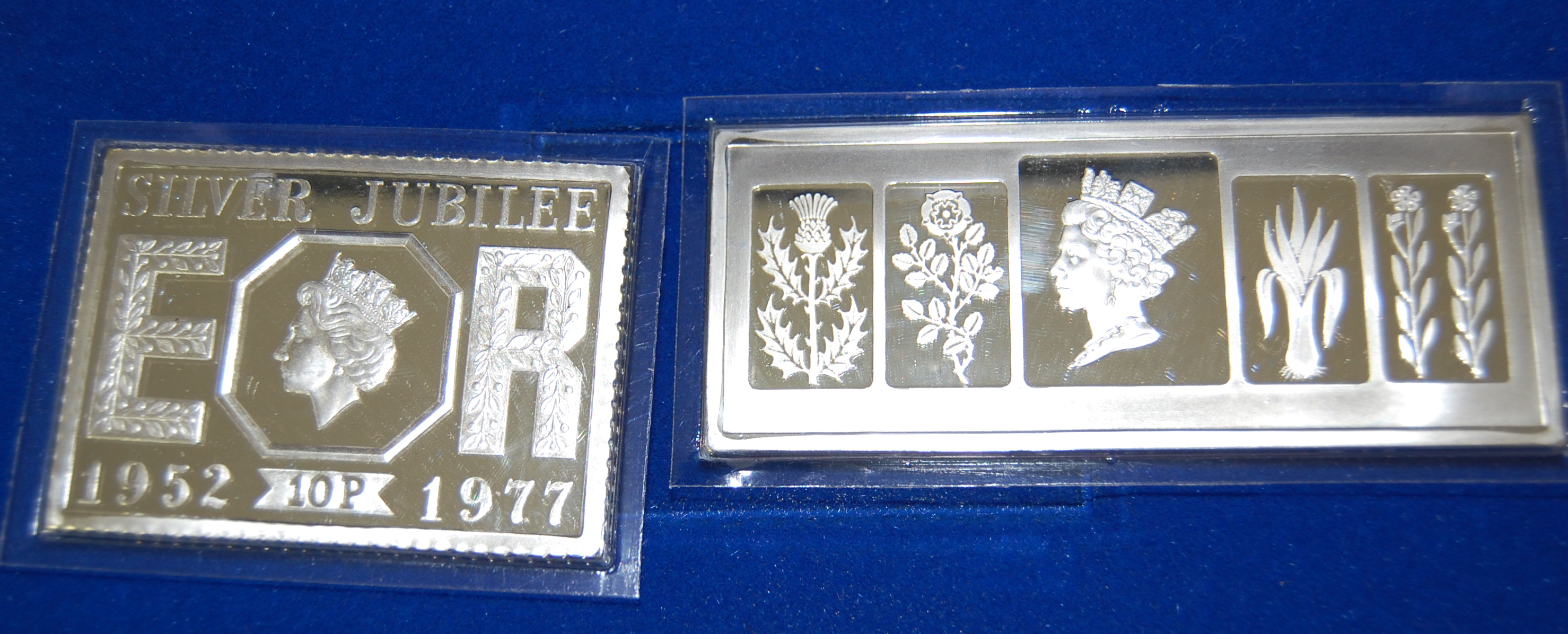 A large group of commemorative ingots and replica stamps