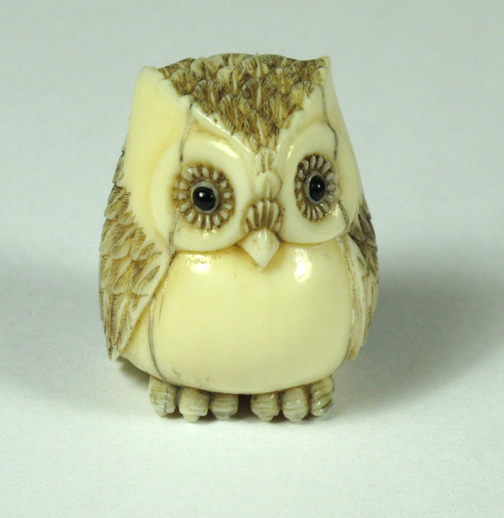 A Japanese carved ivory netsuke of an owl