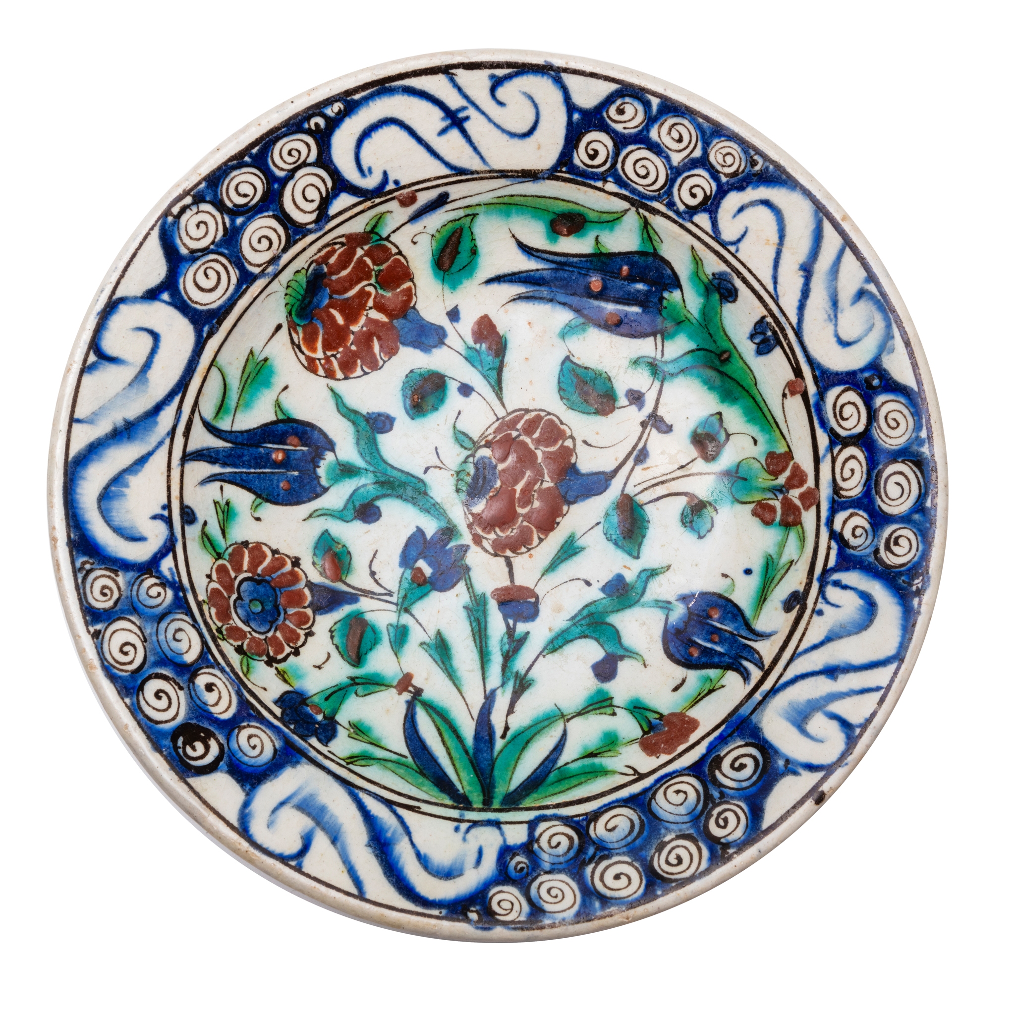 A CLASSIC IZNIK POTTERY DISH DECORATED WITH TULIPS AND ROSES