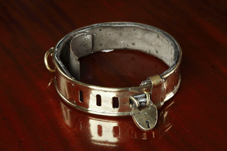 A large Regency adjustable brass dog collar