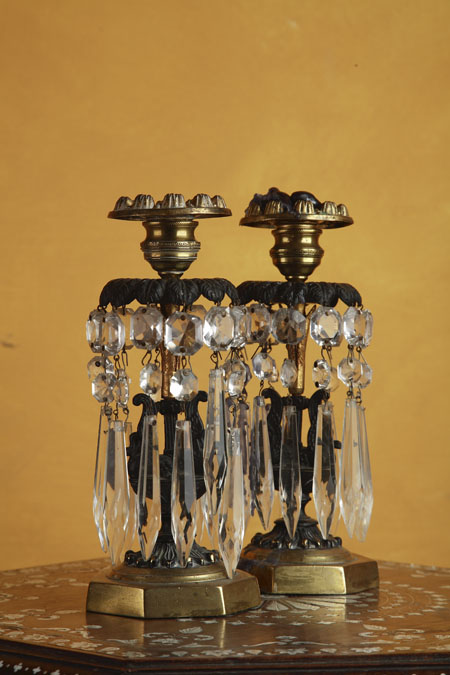A pair of Regency brass, bronze and cut glass candle lustres