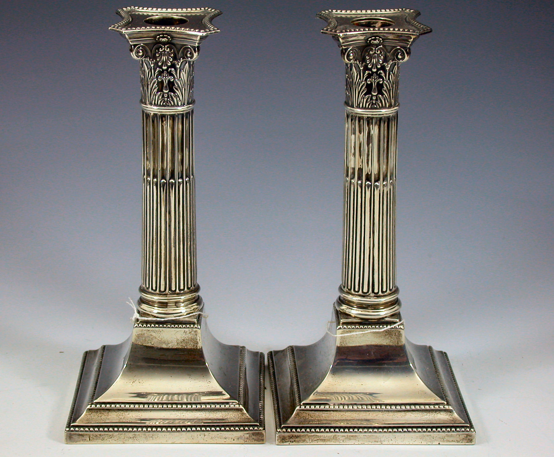 A pair of Edwardian candlesticks,