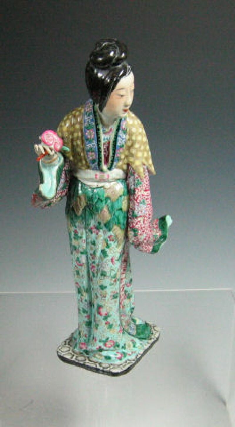 A 19th century ceramic figure of a geisha
