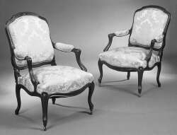 A pair of 19th century rosewood Louis XV style fauteuils