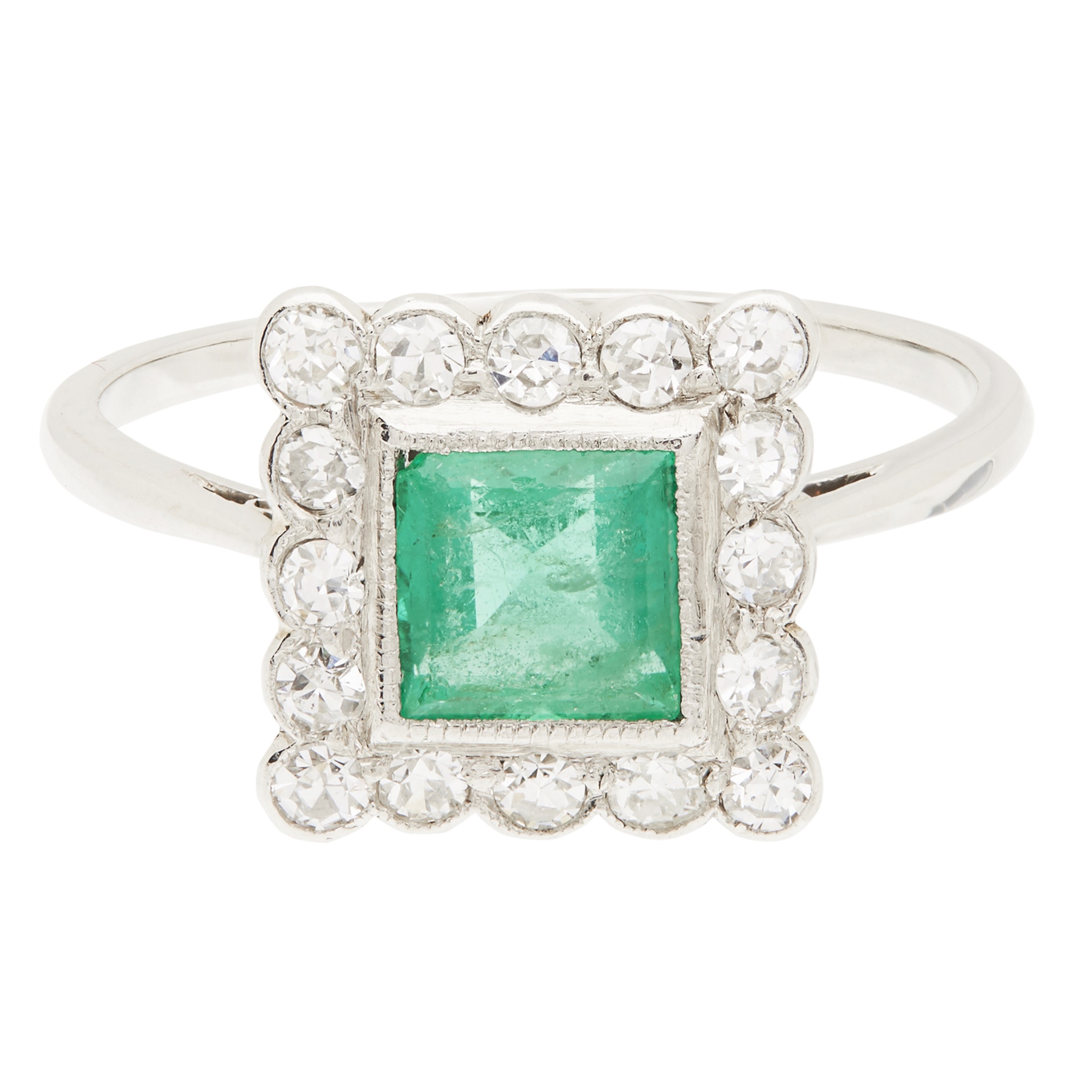 An emerald and diamond set cluster ring