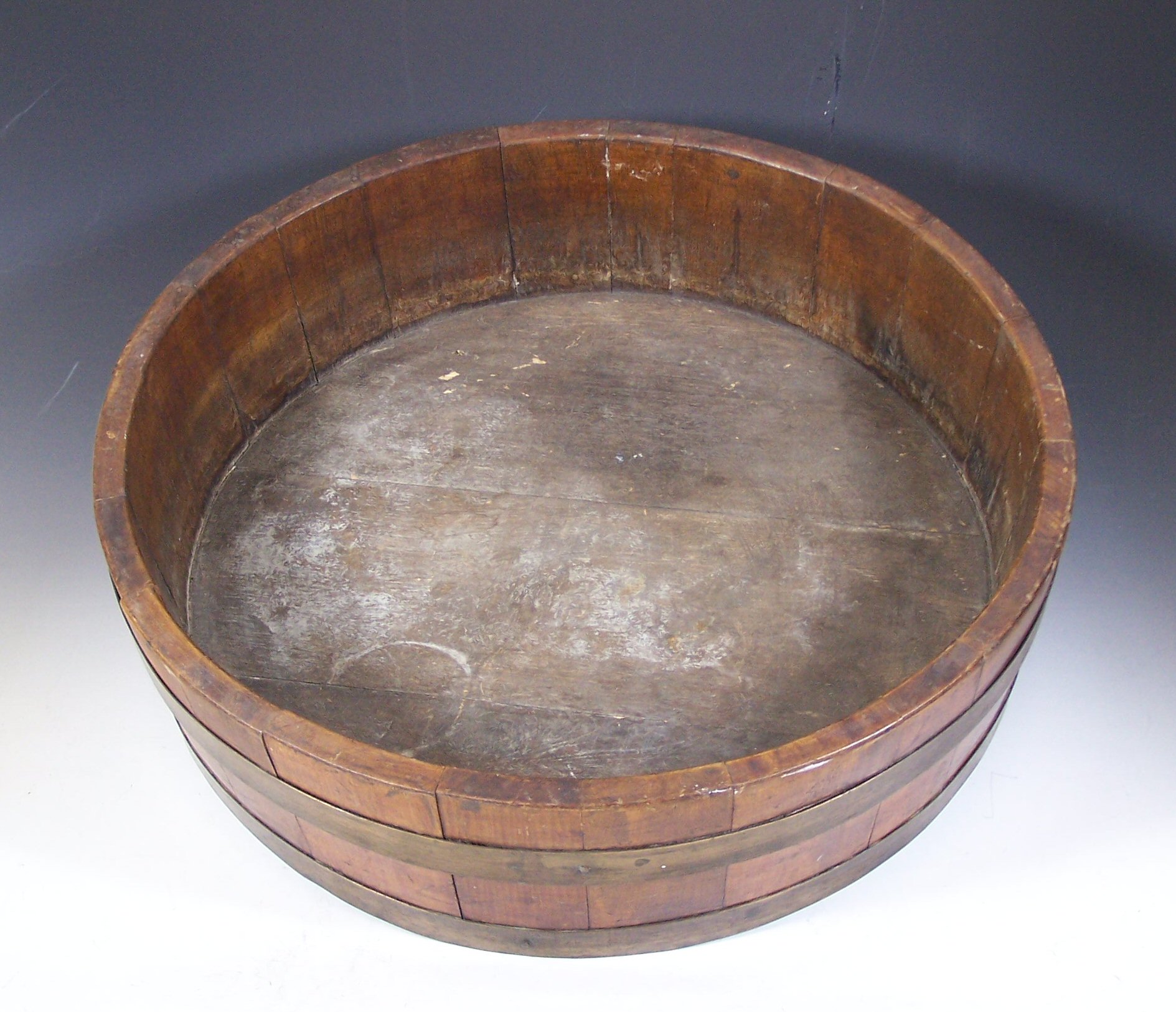 A large circular staved oak and brass bound planter,