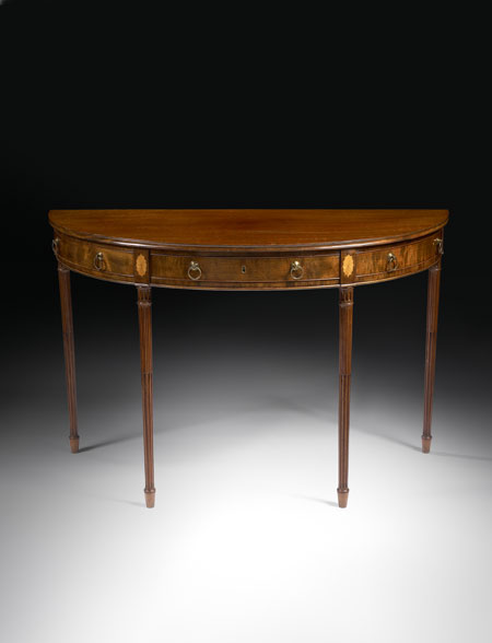 A mahogany and inlaid demi-lune side table