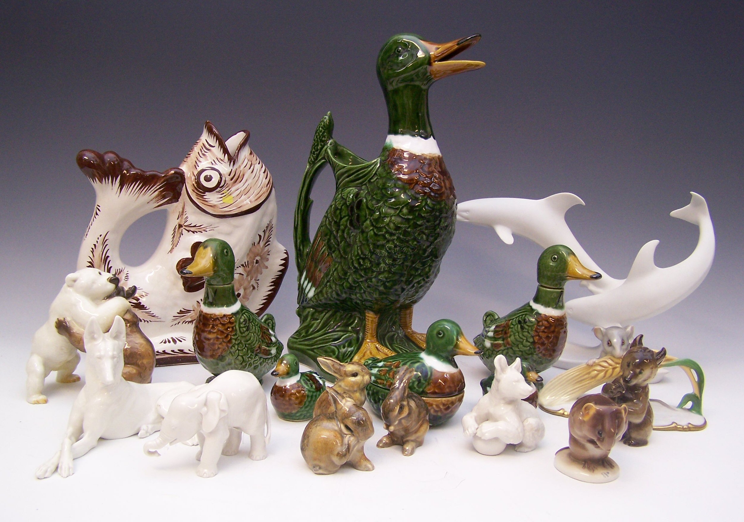 A collection of porcelain and pottery animals, birds and fish,