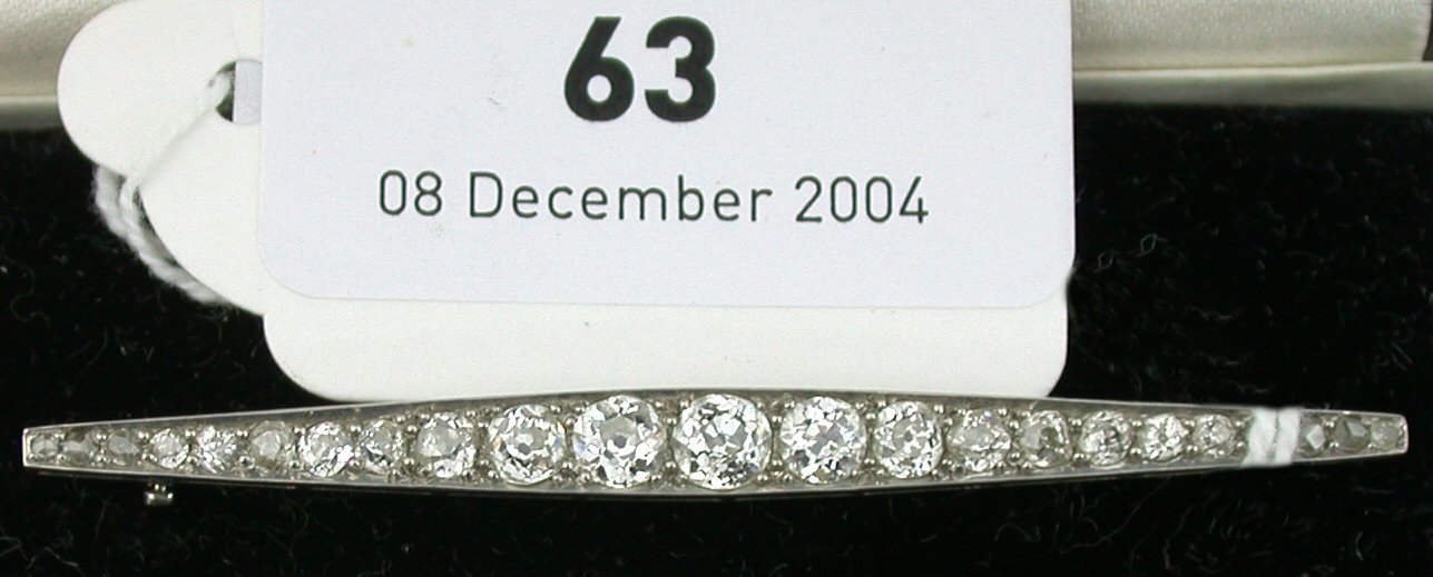 A diamond bar brooch,