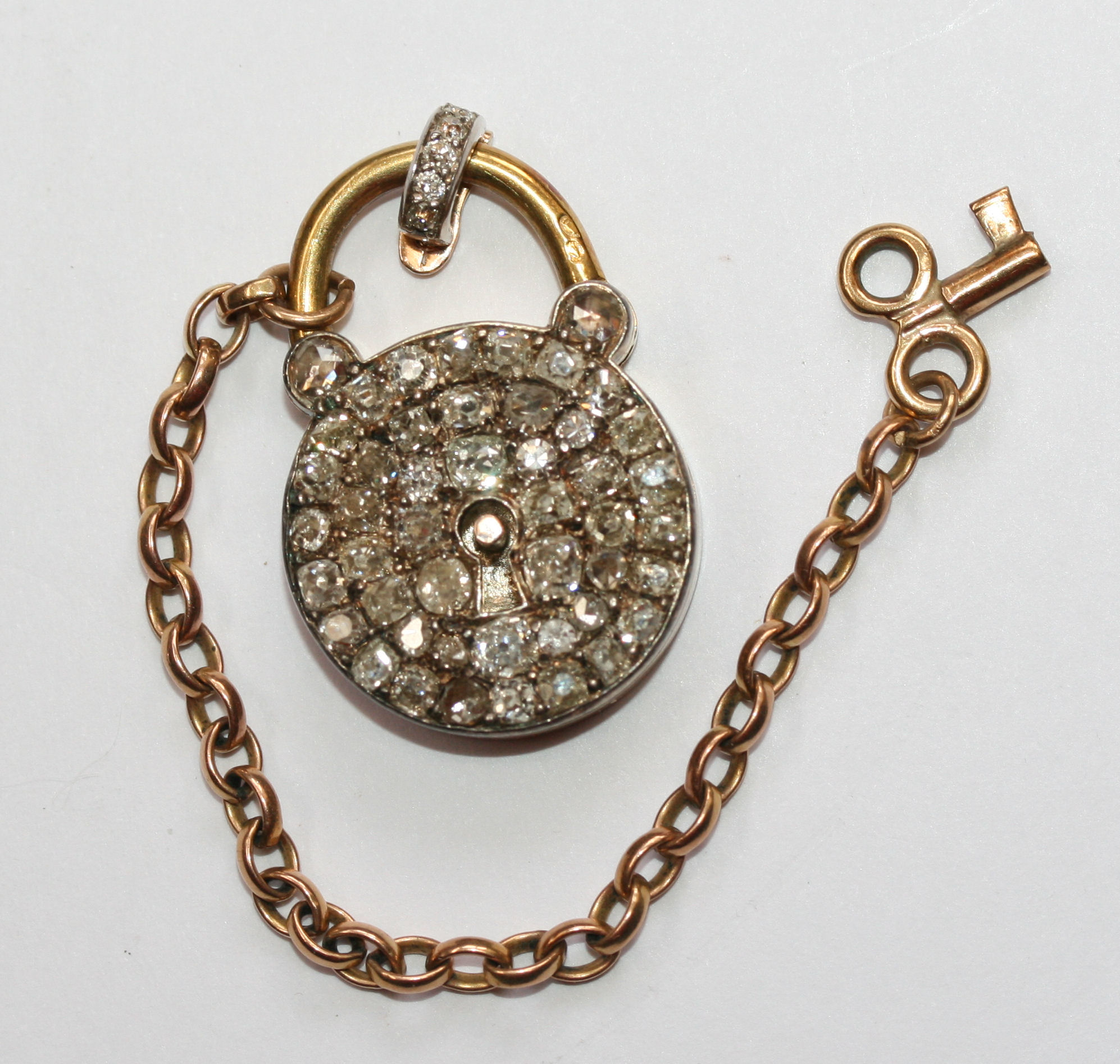 A 19th century central European gold and diamond set padlock with key