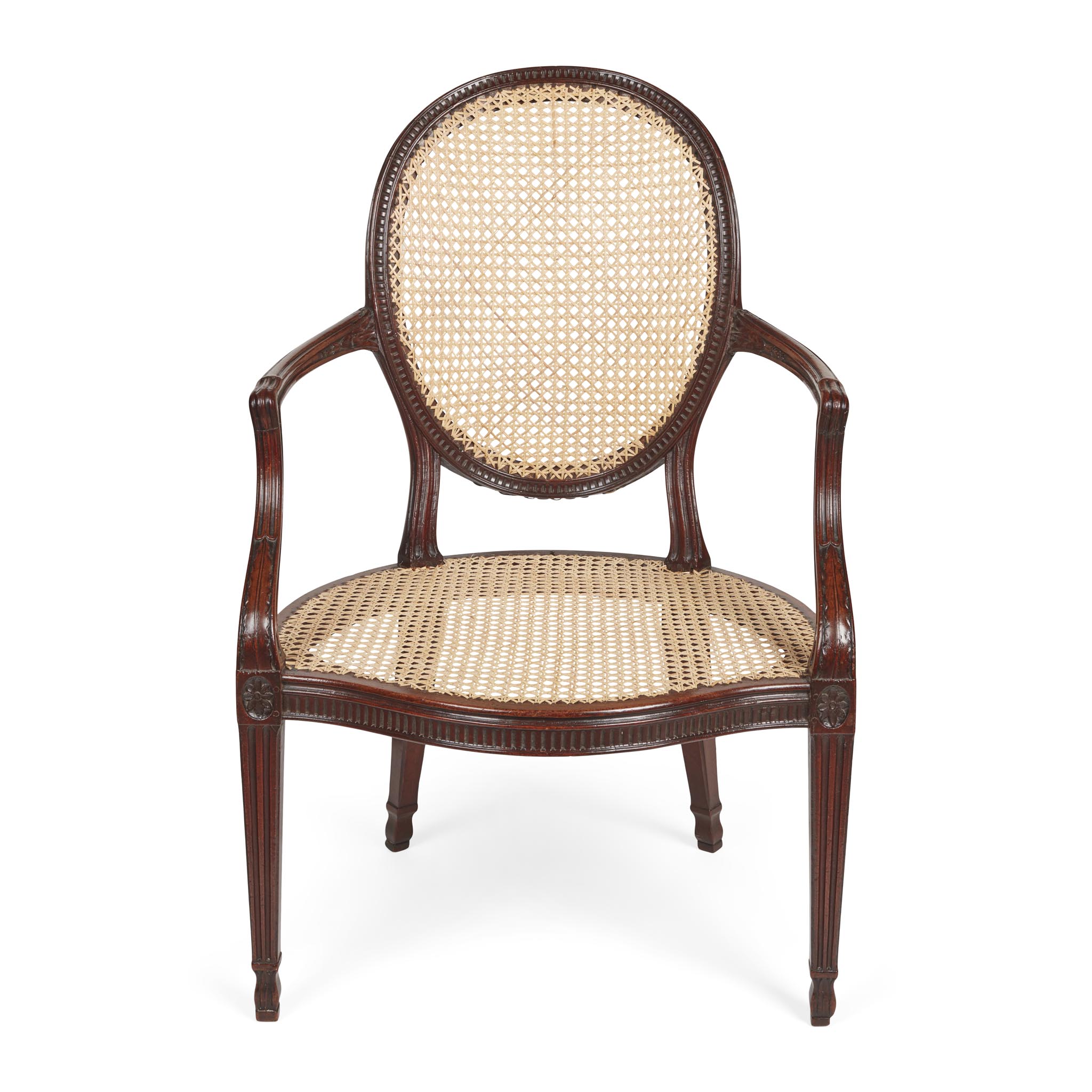 GEORGE III MAHOGANY AND CANED ARMCHAIR, IN THE MANNER OF JOHN LINNELL