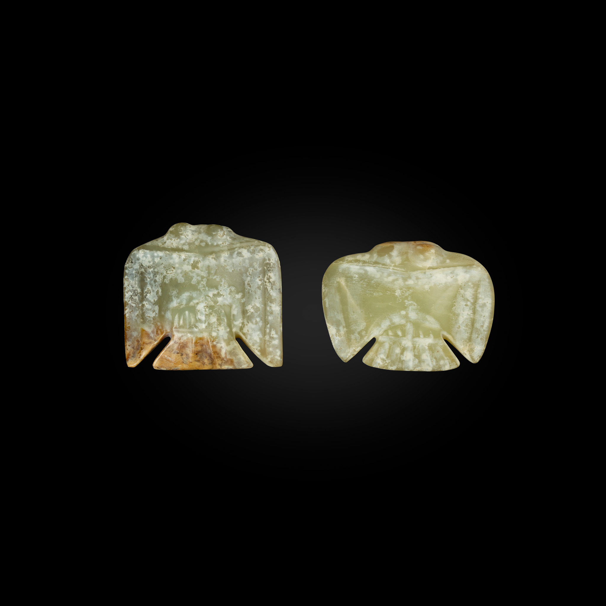 TWO CHINESE CELADON JADE CARVINGS OF BIRD-SHAPED PENDANTS