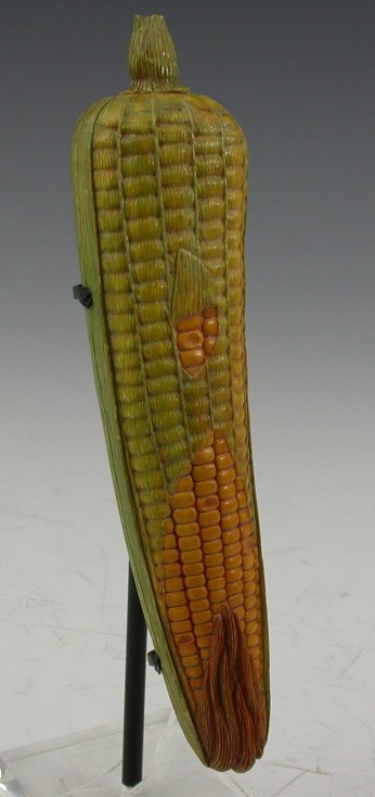 A Chinese carved and stained ivory corn on the cob