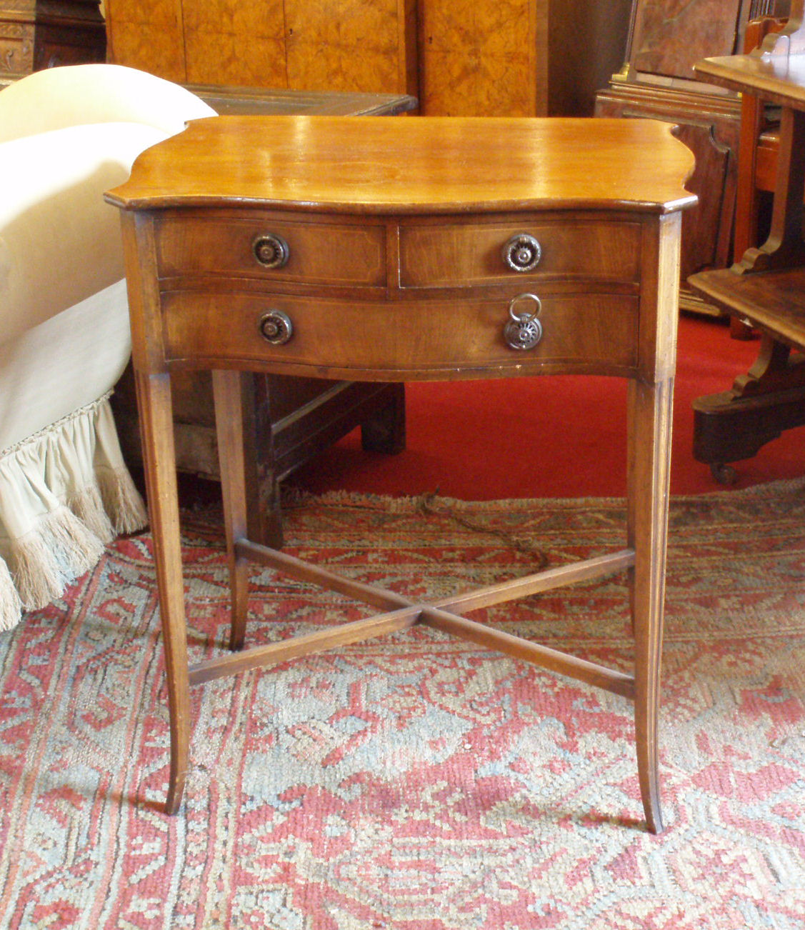 A small mahogany serpentine side table