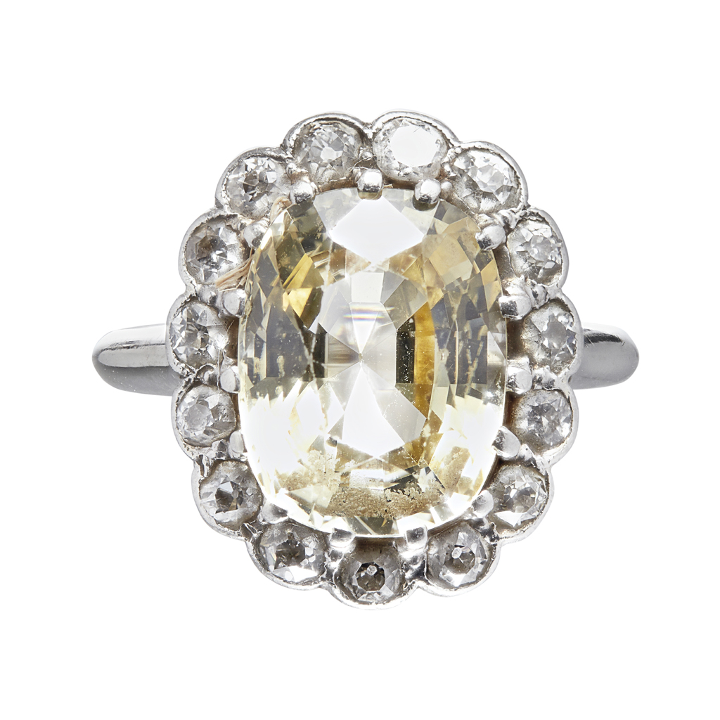 A yellow sapphire and diamond cluster ring