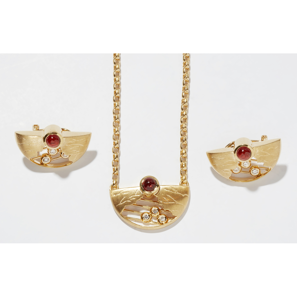 A contemporary garnet and diamond set suite