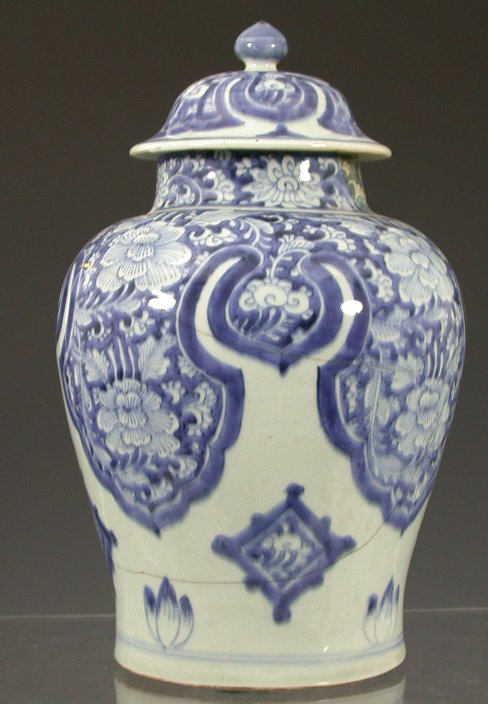 A pair of Chinese early 19th century blue and white vases and covers