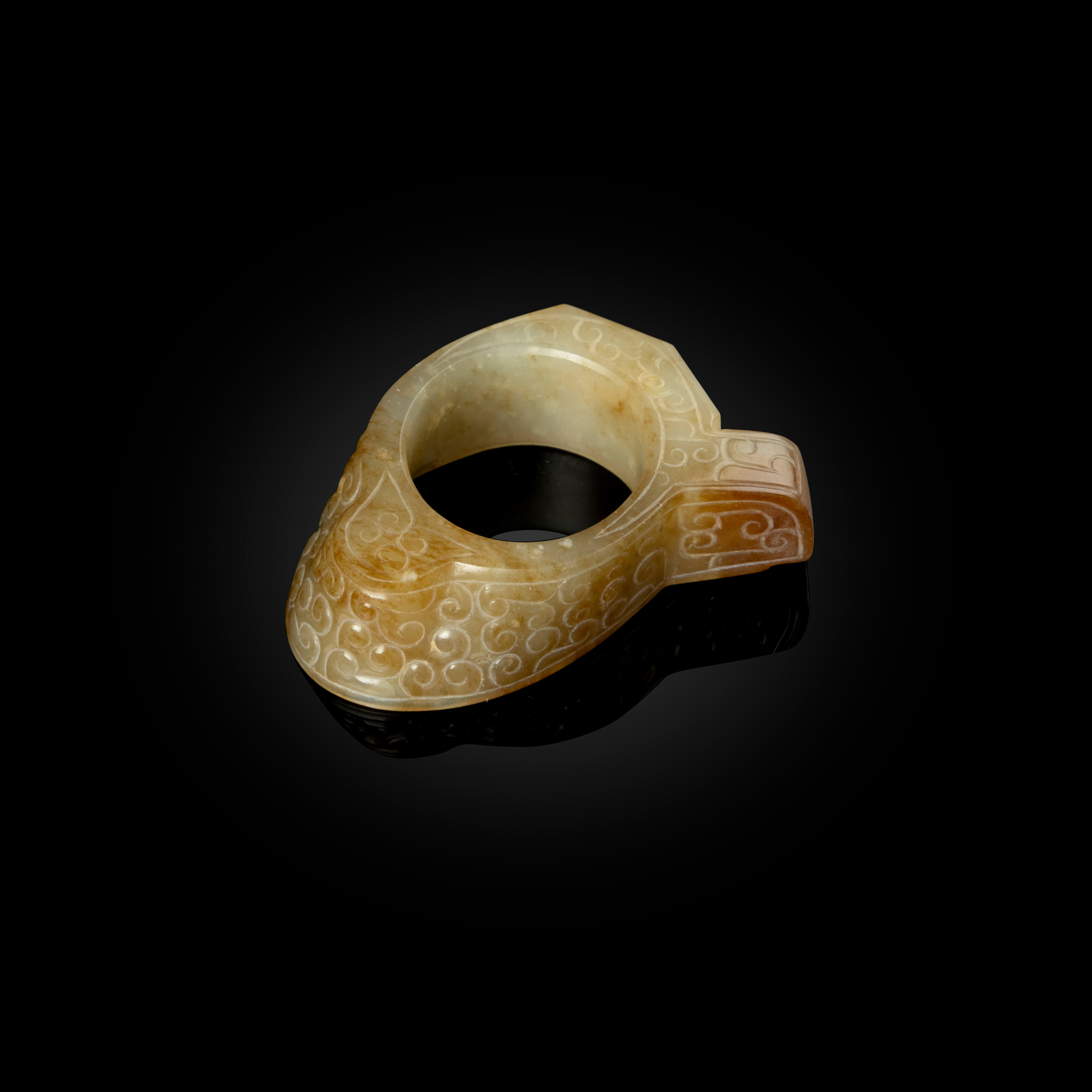 CHINESE PALE CELADON JADE WITH RUSSET INCLUSIONS ARCHER'S RING