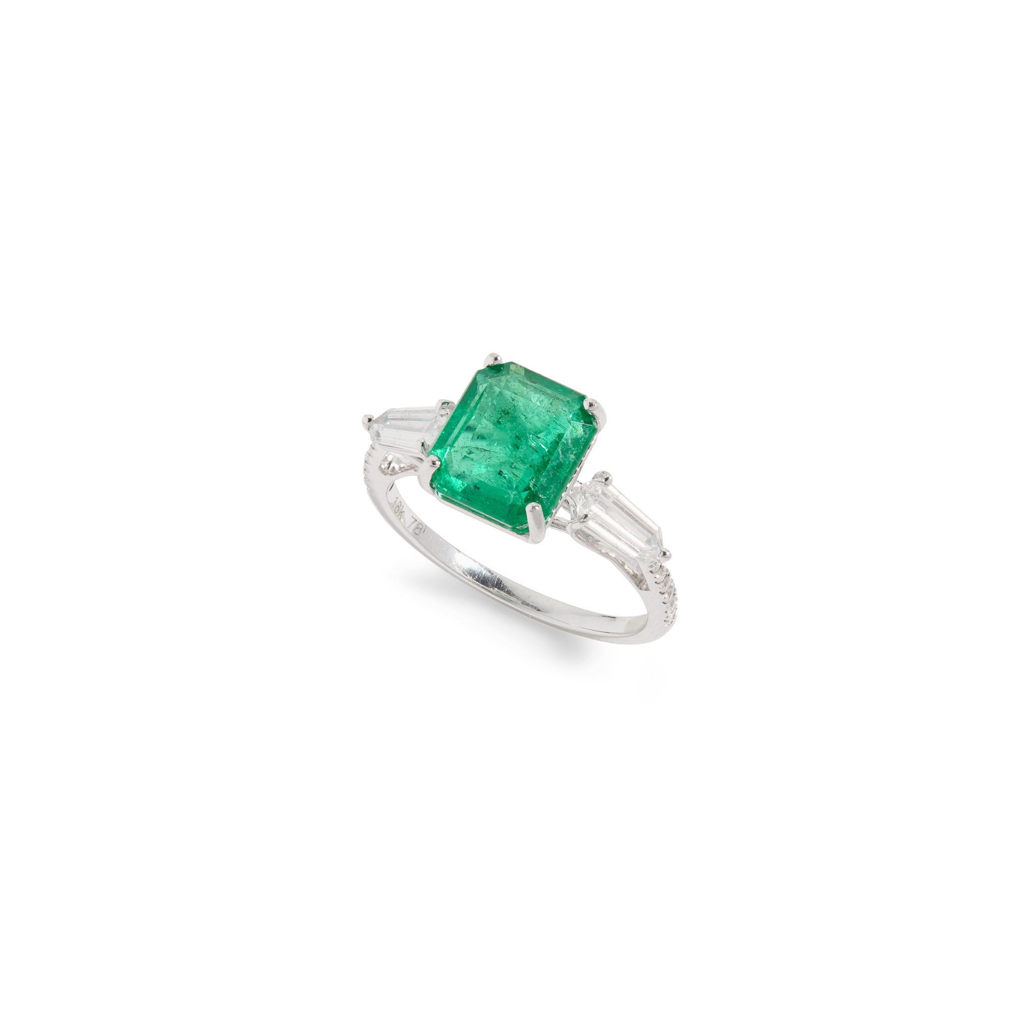 An emerald and diamond three-stone ring
