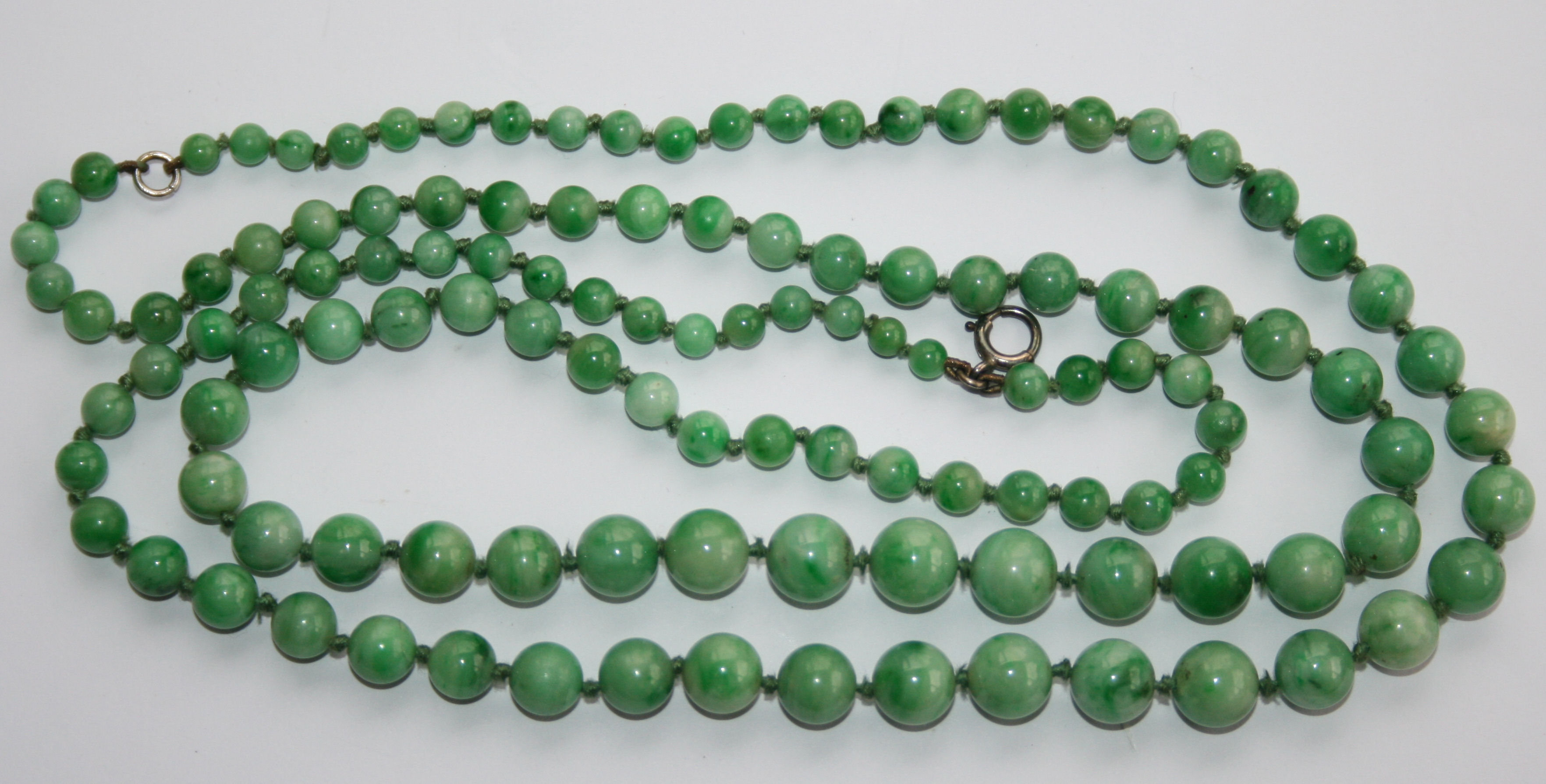 Long strand of graduated jadeite beads